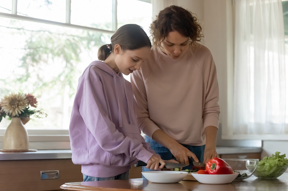 Support Worker and young person cooking in the kitchen