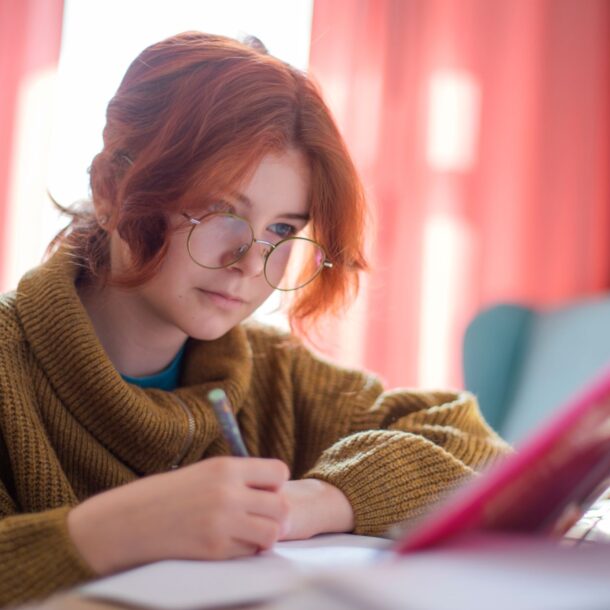 Girl doing homework in bedroom