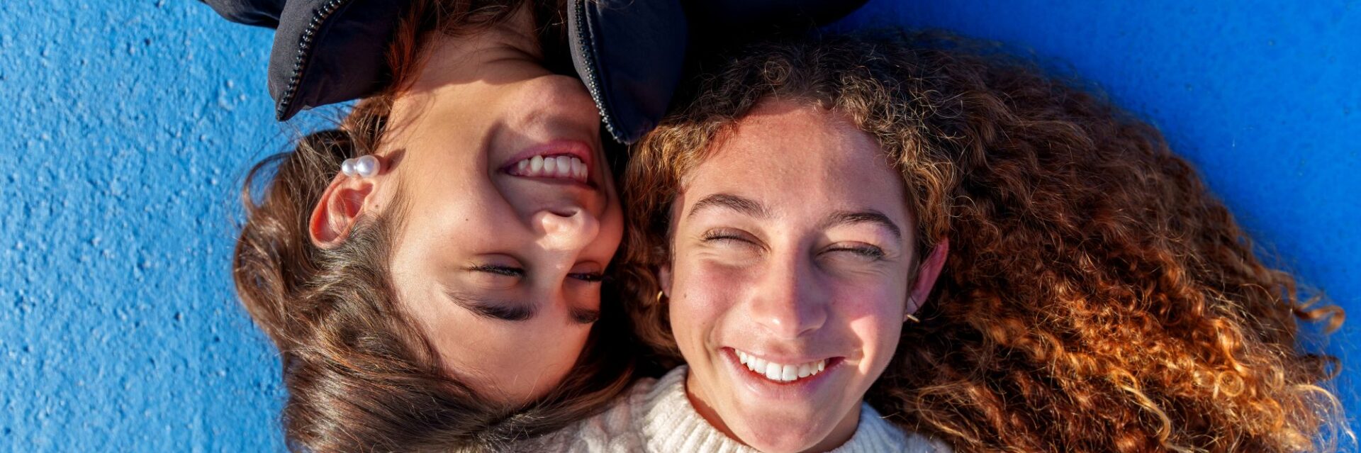 Two girls laughing with each other