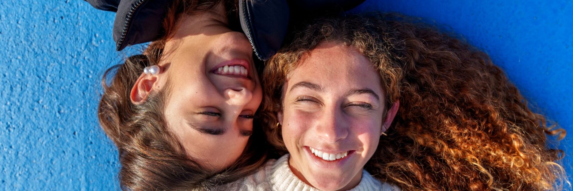 Two girls laughing with each other