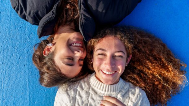 Two girls laughing with each other